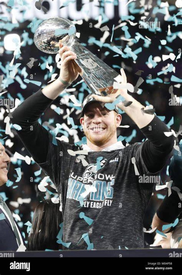 Carson lifting Super Bowl trophy
